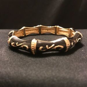Gold tone and black bracelet.